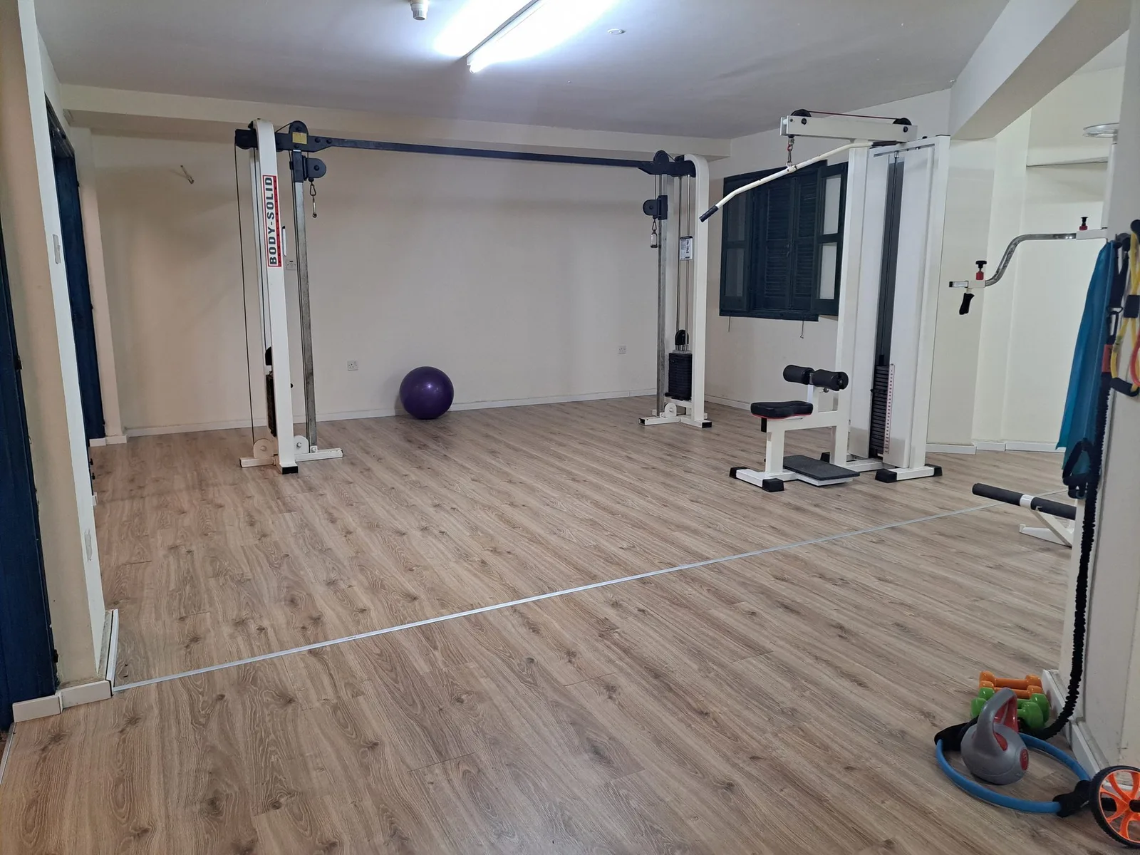 Bright gym with machines and a bike