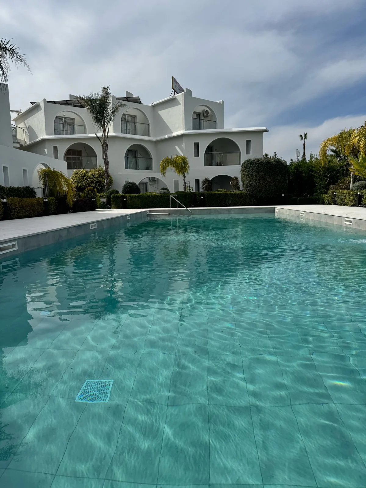 The pool at Pandream with the white arched apartment blocks behind